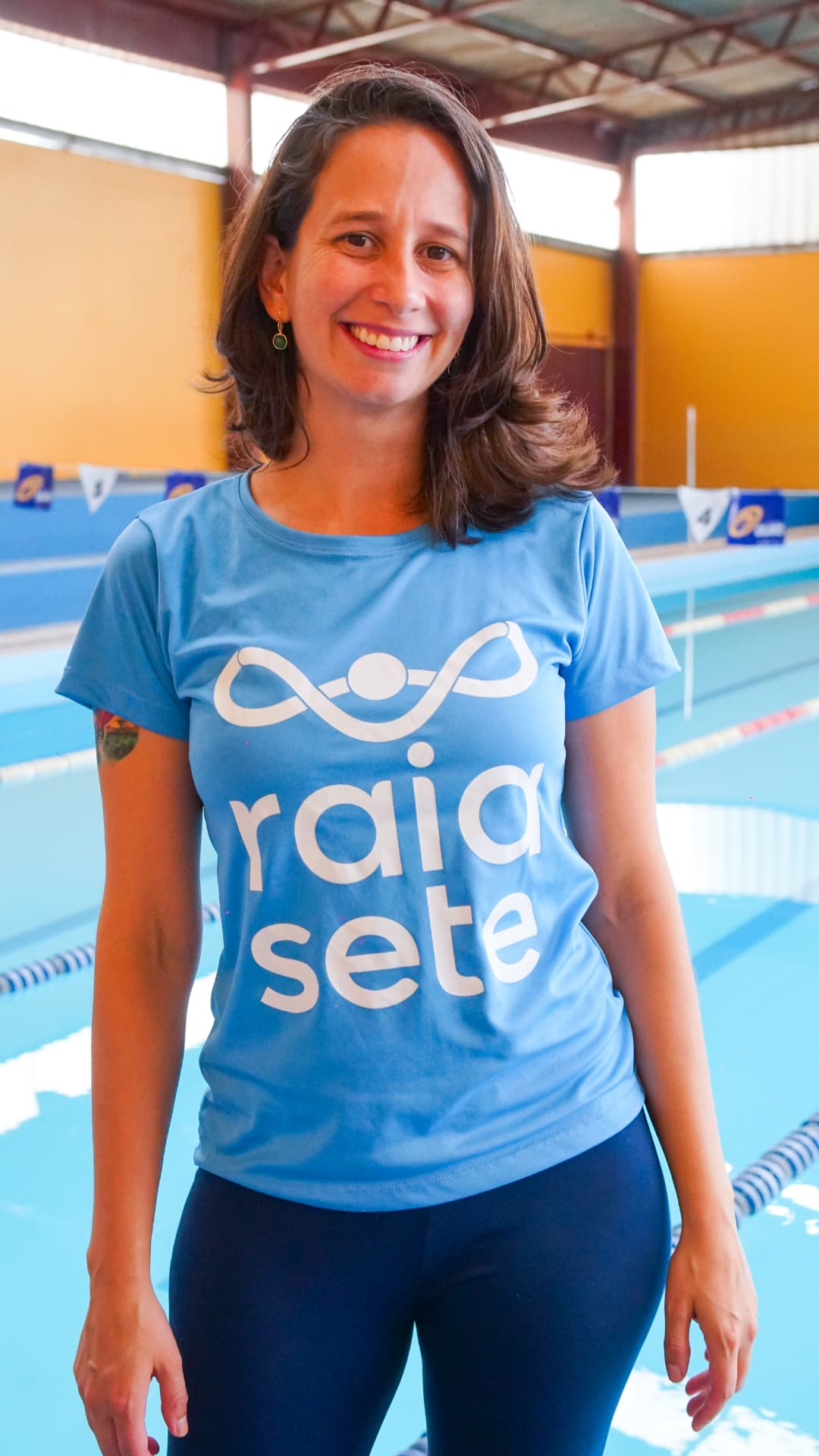 Anna Clara Souza Sobral à beira da piscina com a camiseta da raia sete